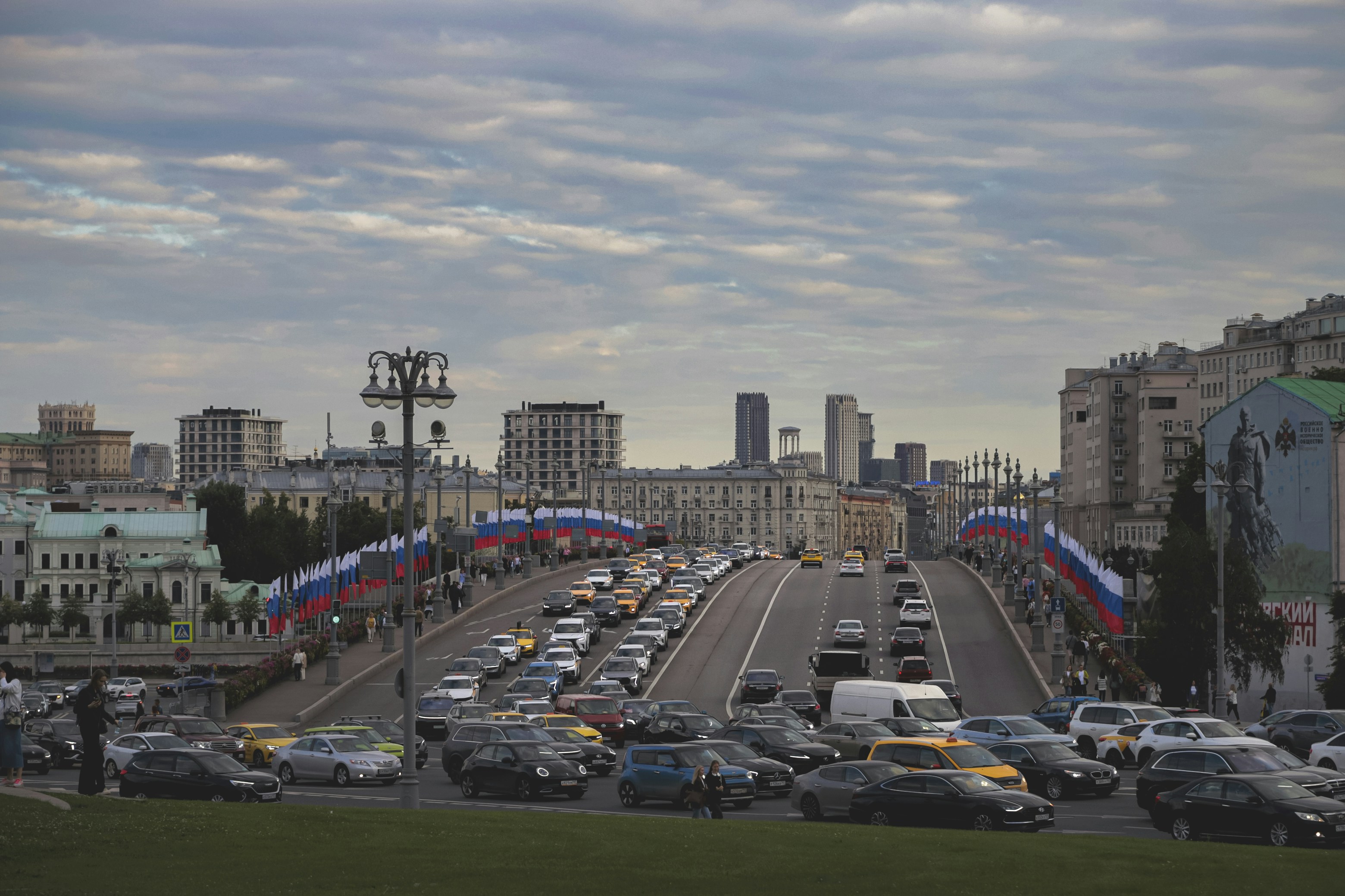 City bridge with heavy traffic and russian flags